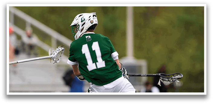 A man in a green jersey with the number 11 on it is running on a field. Description generated by AI