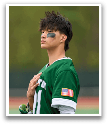 A man wearing a green and white jersey with the number 11 on it. Description generated by AI