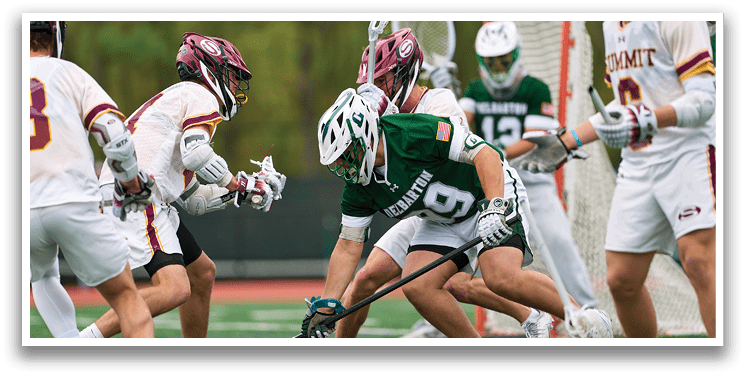 A group of men playing a game of lacrosse. Description generated by AI