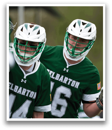 Two men wearing green and white uniforms. Description generated by AI
