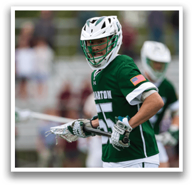 A man wearing a green and white shirt with the number 15 on it. Description generated by AI