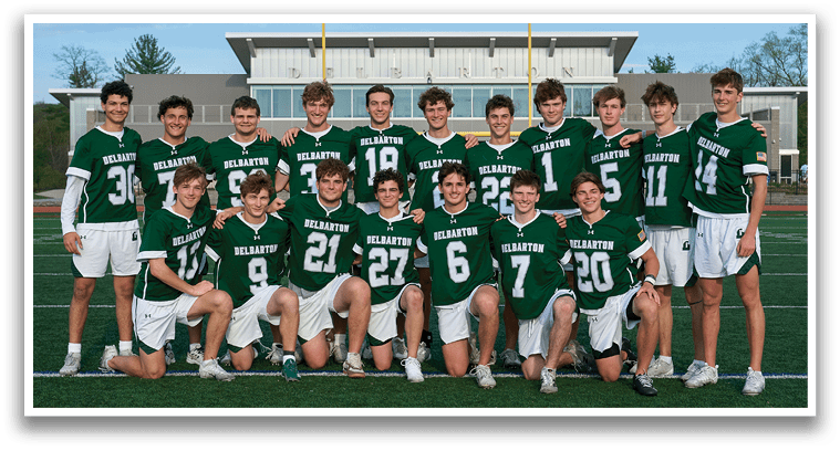 A group of young men in green and white uniforms pose for a picture. Description generated by AI