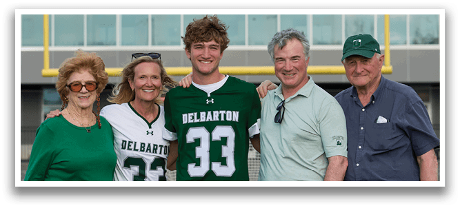 A group of people standing together, one of them wearing a jersey with the number 33. Description generated by AI