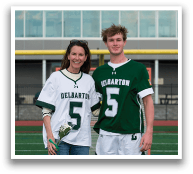 A man and a woman wearing Delaware jerseys. Description generated by AI