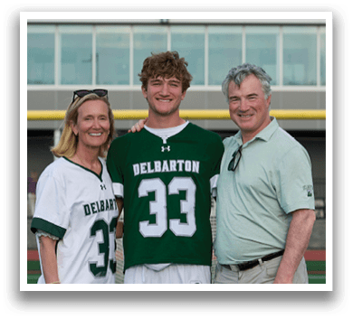 A man and woman are standing next to a football player. Description generated by AI