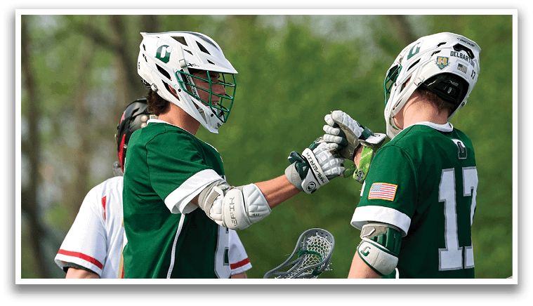 Two men wearing green shirts and white shorts are shaking hands. Description generated by AI