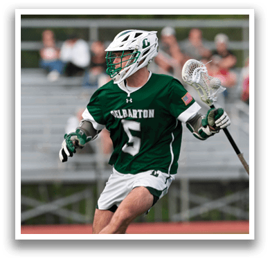 A man wearing a green and white jersey with the number 5 on it. Description generated by AI