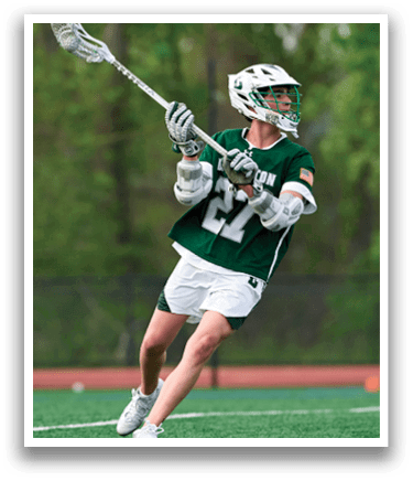 A man in a green and white shirt is holding a lacrosse stick. Description generated by AI