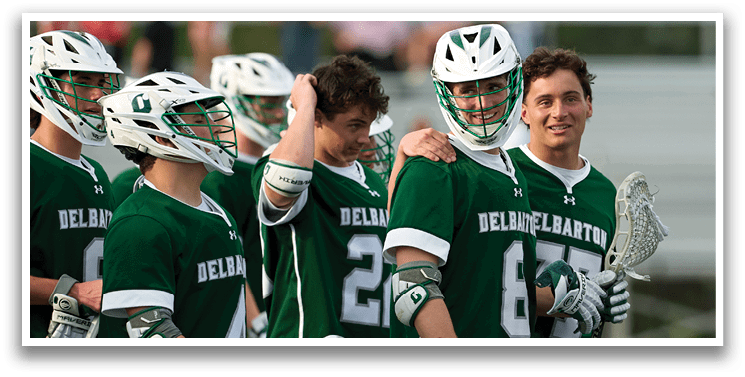 A group of men wearing green jerseys. Description generated by AI