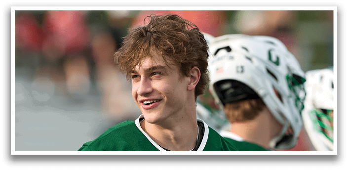 A man wearing a green jersey with the number 11 on it. Description generated by AI