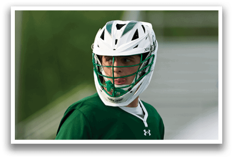 A man wearing a green and white uniform with the number 26 on it. Description generated by AI