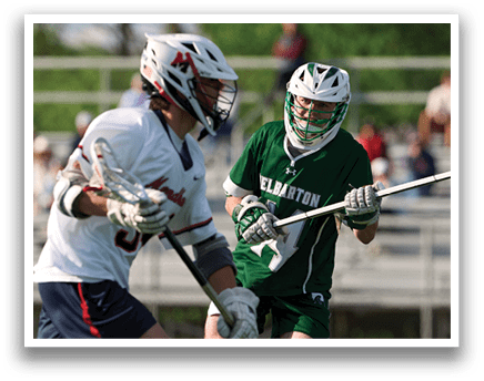 A man wearing a green shirt and white shorts is holding a stick. Description generated by AI