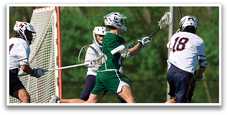 A group of men playing lacrosse. Description generated by AI