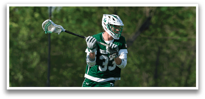 A man wearing a green and white uniform is running on a field. Description generated by AI