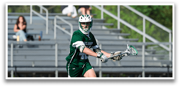 A man wearing a green and white uniform is running on a field. Description generated by AI