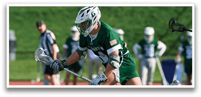 A man wearing a green jersey is running on a field. Description generated by AI