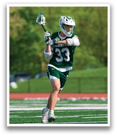 A man in a green and white uniform is holding a lacrosse stick. Description generated by AI
