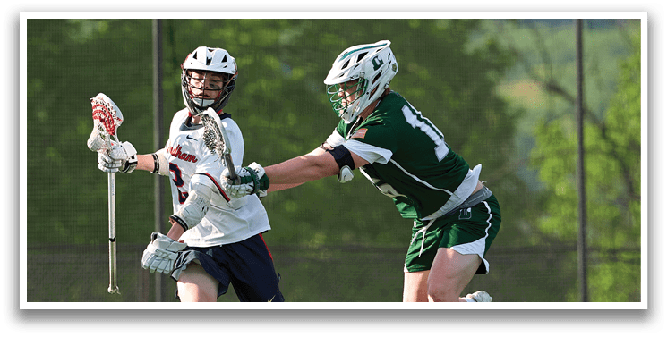 A boy in a white shirt and blue shorts is running with a lacrosse stick. Description generated by AI