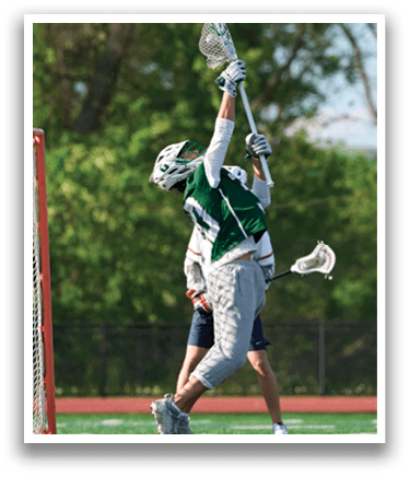 A man in a green and white uniform is jumping in the air to catch a lacrosse ball. Description generated by AI