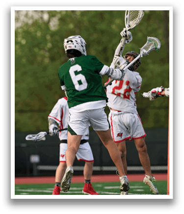 A group of men playing lacrosse. Description generated by AI