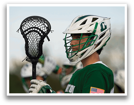 A man holding a lacrosse net. Description generated by AI