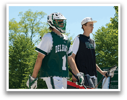 Two men wearing green and white uniforms. Description generated by AI