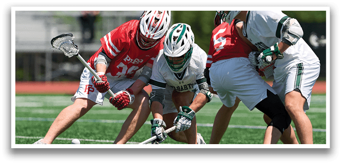 A group of men playing a game of lacrosse. Description generated by AI