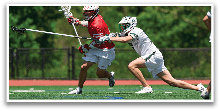 A man in a red shirt and white shorts is running with a lacrosse stick. Description generated by AI