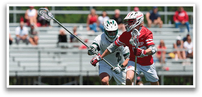 Two men playing lacrosse on a field. Description generated by AI