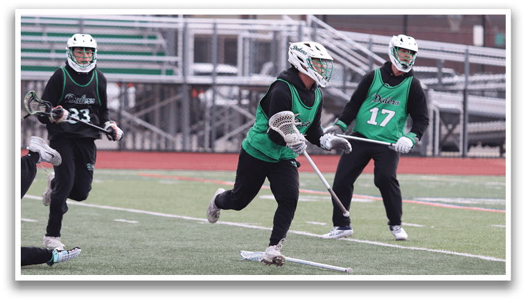 Three people wearing green and black uniforms are playing a game of lacrosse on a field. AI generated content