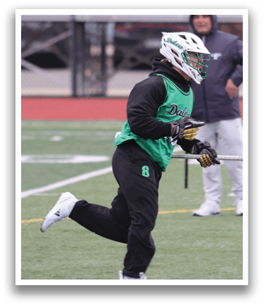 A man in a green and white uniform is holding a lacrosse stick and running on a field. AI generated content