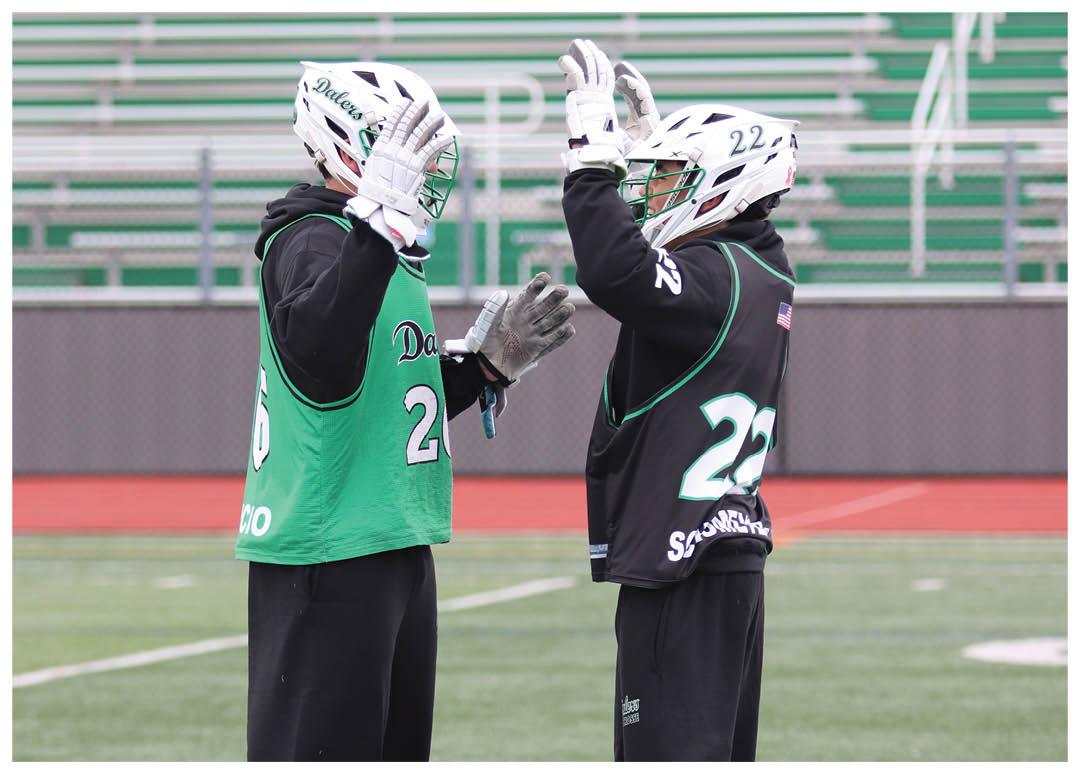 Two men wearing green and black uniforms are standing on a field, holding their baseball gloves. AI generated content