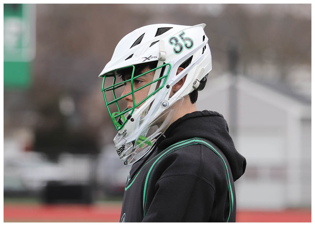 A man wearing a helmet and a catcher's mitt is standing on a field. AI generated content