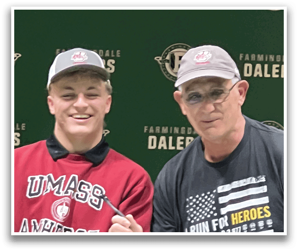 Two men are standing in front of a green backdrop, one of them holding a pen. AI generated content