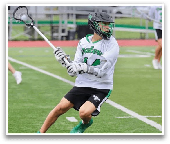 A man in a white and green uniform is holding a lacrosse stick and preparing to shoot the ball. AI generated content