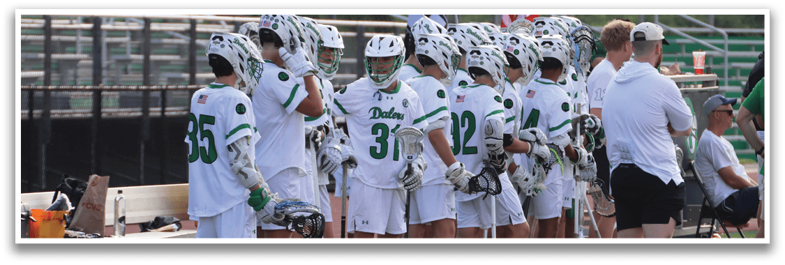 A group of people standing on a field with their lacrosse sticks. Description generated by AI