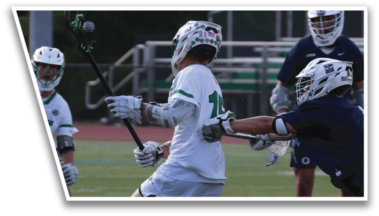 A group of men playing a game of lacrosse on a field. Description generated by AI