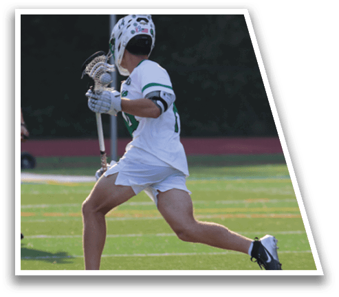 A man in a white uniform is playing lacrosse. Description generated by AI