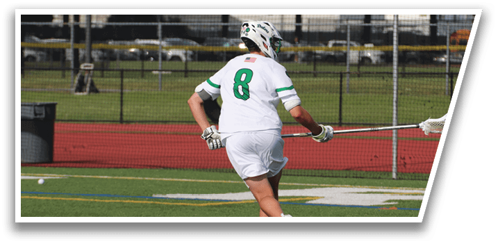 A man wearing a white and green jersey is running on a field. Description generated by AI