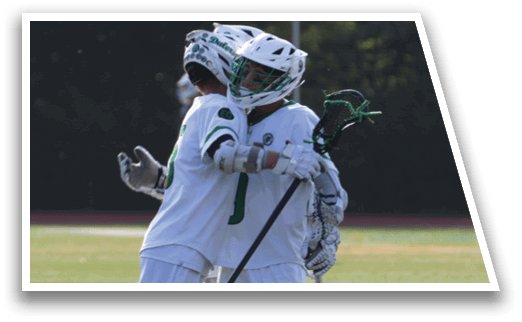 Two men hugging on a field. Description generated by AI