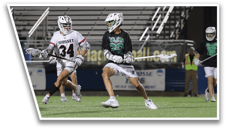A group of men playing lacrosse on a field. Description generated by AI