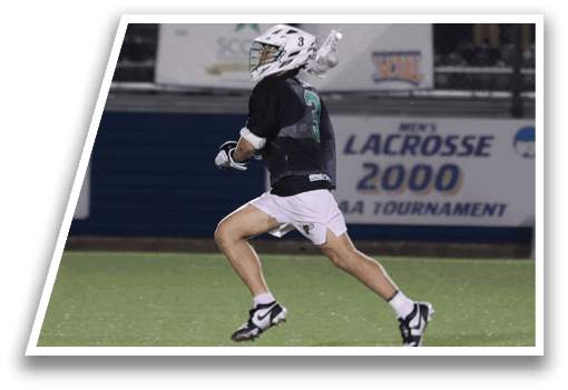 A man running on a field with a green and white helmet. Description generated by AI