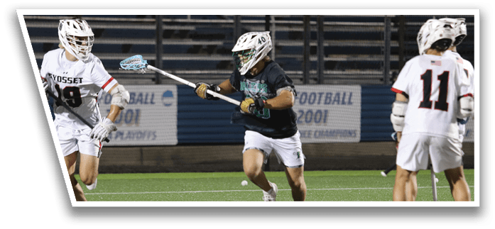 A group of men playing lacrosse on a field. Description generated by AI