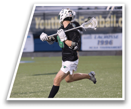 A man is playing lacrosse on a field. Description generated by AI