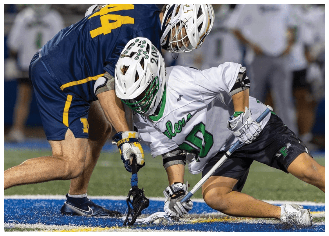 A man in a blue shirt is holding a hockey stick. Description generated by AI