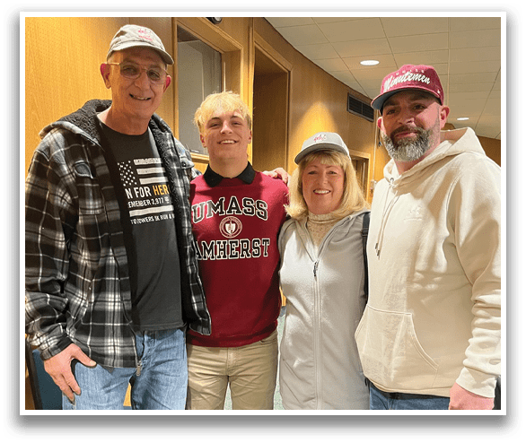 Four people pose for a picture, two men and two women, all wearing jeans and white shoes. AI generated content