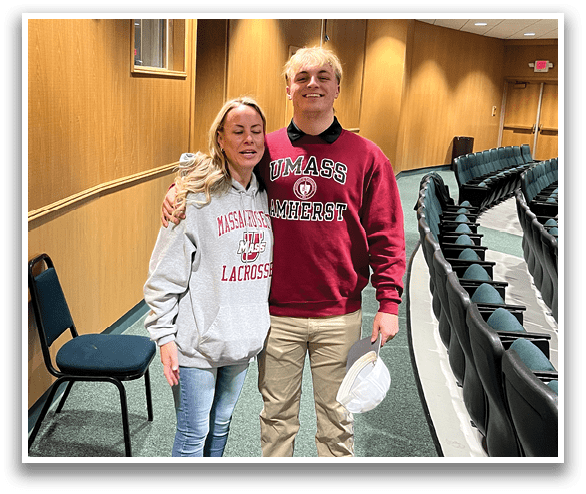 A man and woman are standing in a room, both wearing red shirts. The woman is wearing a white shirt. AI generated content