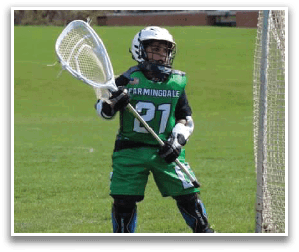 A young boy wearing a green jersey and holding a lacrosse stick. AI generated content