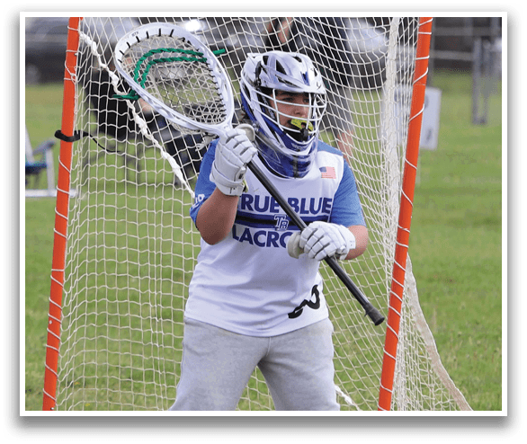 A young man in a blue and white shirt is holding a lacrosse stick in front of a net. AI generated content