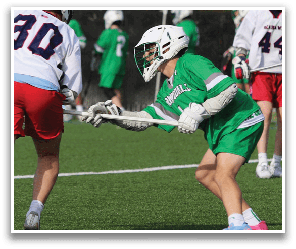 A boy in a green shirt and shorts is playing lacrosse. AI generated content